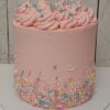Pink Simply Sprinkles Cake with buttercream swirls and pastel sprinkles