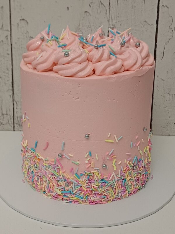 Pink Simply Sprinkles Cake with buttercream swirls and pastel sprinkles