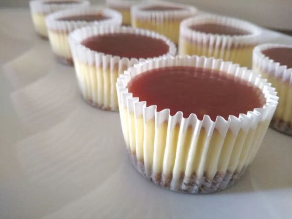 Cheesecake Cupcakes — Box of 12 Individual cheesecake cupcakes in white paper cases with a biscuit base and glossy topping