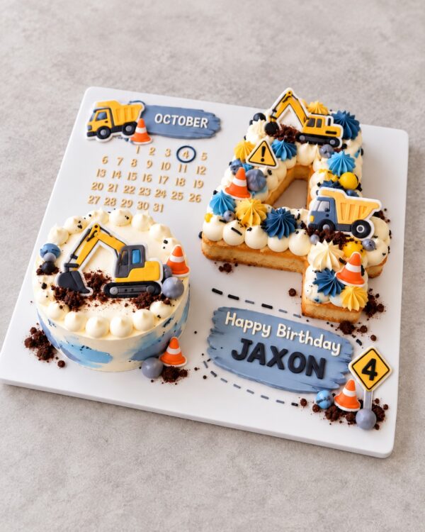 Construction-themed Soeterie Celebration Board with a round mini cake, layered number 4 cookie cake, yellow diggers, trucks, traffic cones and personalised birthday details on a square board.